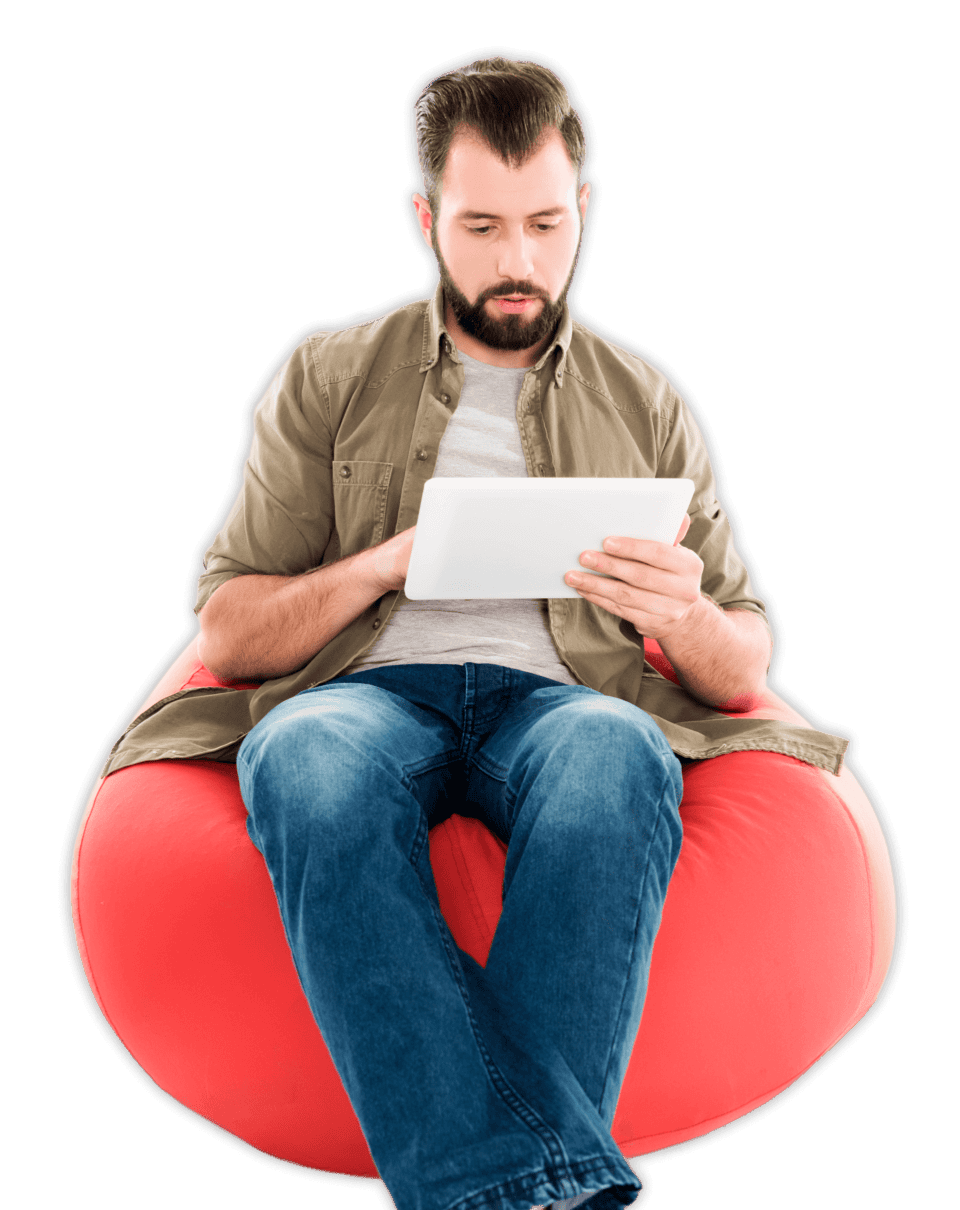 man sitting reading on ipad