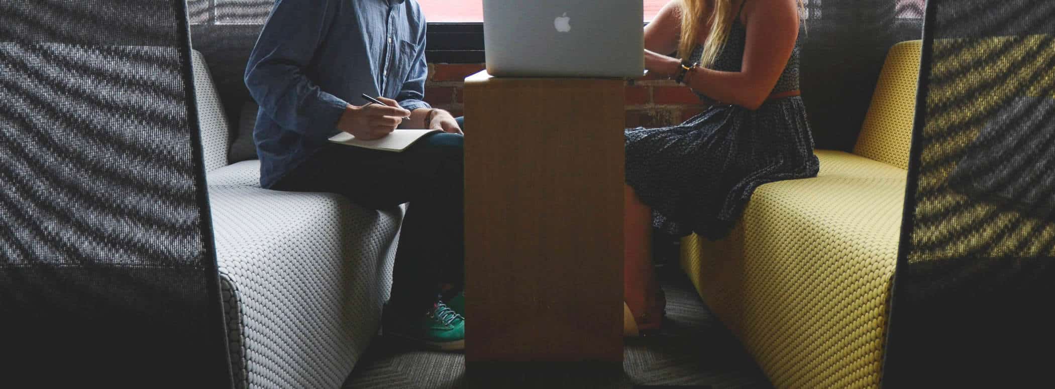 Two people sitting for a meeting at a table