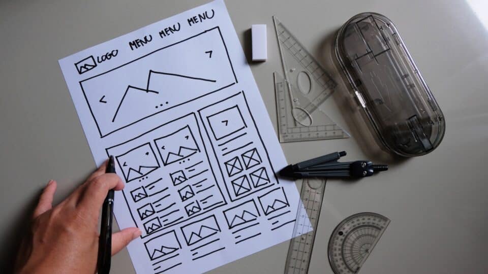 web designer desk with website wireframe sketches