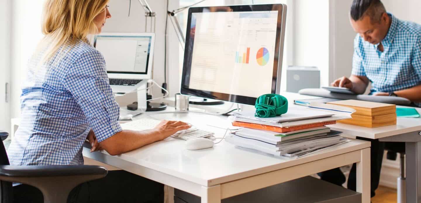 Man and woman working on computers